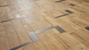 light color mix of hardwood and metal inlays flooring trend 2025