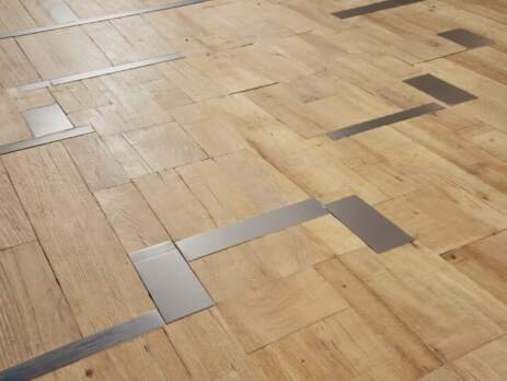 light color mix of hardwood and metal inlays flooring trend 2025