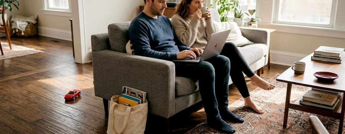 Homeowners relaxing on wide plank hardwood floor