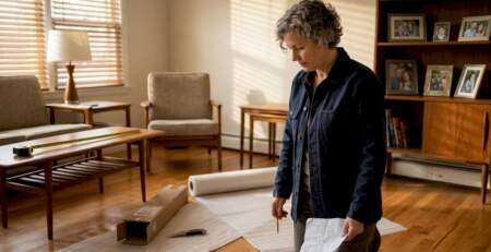 Person installing wood floor underlayment at home