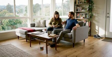 Couple relaxing in living room with modern hardwood floor