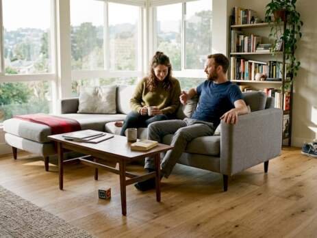 Couple relaxing in living room with modern hardwood floor