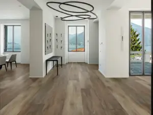Chivalry Paradigm Flooring Conquest 20MIL SPC installed in open entry hallway with dining beyond — medium brown — Santa Clara