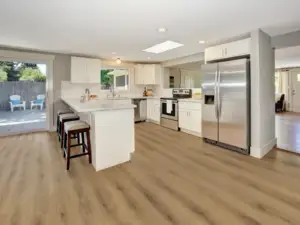 Drawbridge Paradigm Flooring Conquest 20MIL SPC installed in kitchen — light brown with honey-amber tones — Palo Alto