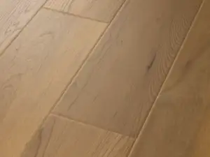 Essex Maple COREtec Pro Premium close-up — scattered small dark knots on 6mm waterproof SPC with 20 mil wear layer
