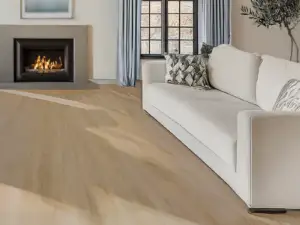 Lake Ercina ST002 Lago Smart Collection 6mm SPC 9-inch planks, warm oak in a living room.