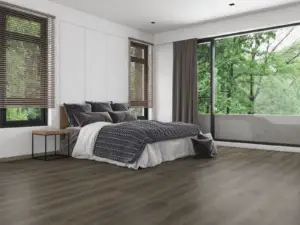 Oriole Paradigm Flooring Performer PLUS SPC installed in modern bedroom with garden view — cool deep grey-brown — Campbell