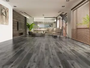 River Shoal SPC flooring in an industrial living room, weathered deep grey cooled toward charcoal.