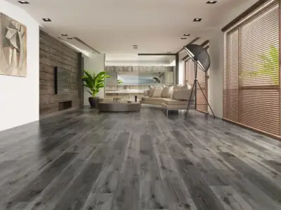 River Shoal SPC flooring in an industrial living room, weathered deep grey cooled toward charcoal.