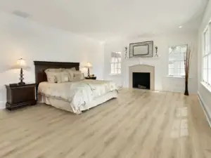 Utopia Paradigm Flooring Conquest 20MIL SPC installed in primary bedroom — creamy tan with golden tones — Newark