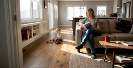 Family relaxing in bright hardwood living room